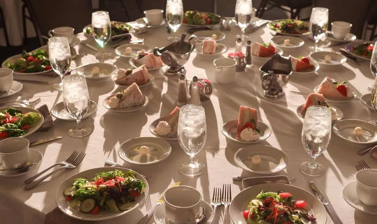Elegant dining setup at Lancaster County Convention Center with salads and drinks.