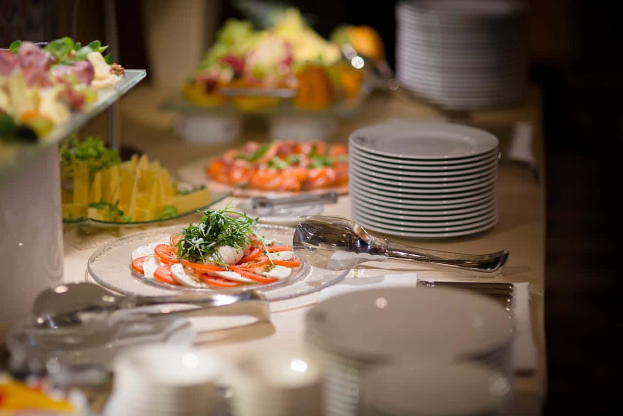 Buffet table with seafood, salads, and plates at Lancaster Convention Center.